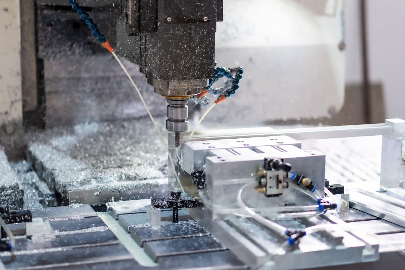 Fresatrice CNC durante la lavorazione di un componente metallico.